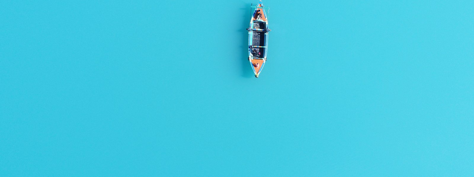 "Boat ride on Attabad Lake in Hunza Valley with turquoise water and mountain backdrop"